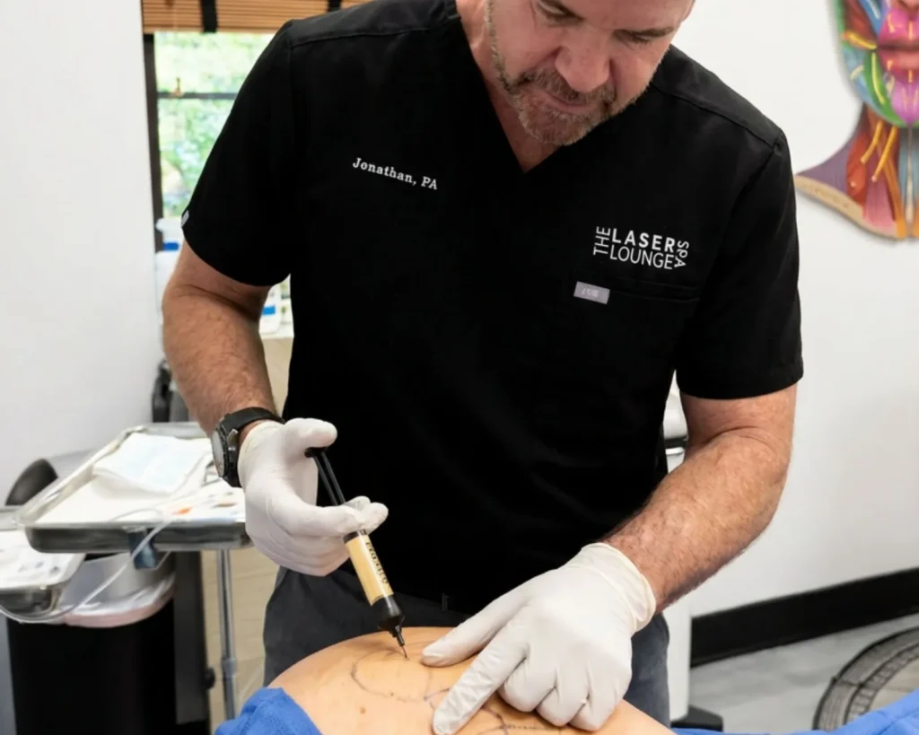 Jonathan, PA, treating a patient's marked body contour area at The Laser Lounge Spa